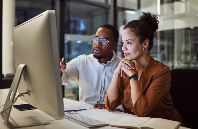 IT professionals reviewing systems together